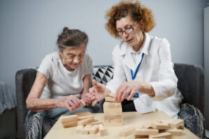 Female nurse caring for older woman dementia awareness mental health therapy support counselling psychotherapy