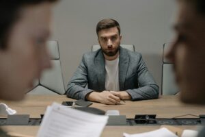 man struggling in silence in the workplace under pressure