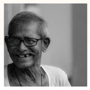 Older man smiles in the safe care and company of kindness