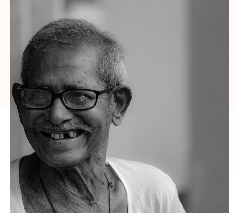 Older man smiles in the safe care and company of kindness